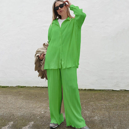 Conjunto deportivo informal de dos piezas para mujer: blusa holgada de manga larga con pliegues y botonadura sencilla y pantalón ancho de color liso.