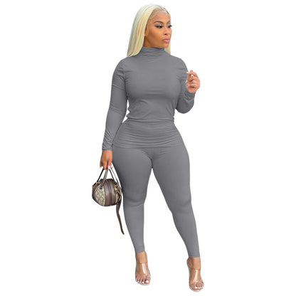 Conjunto de dos piezas de top y pantalones ajustados de manga larga con cuello alto y color liso de talla grande para mujer