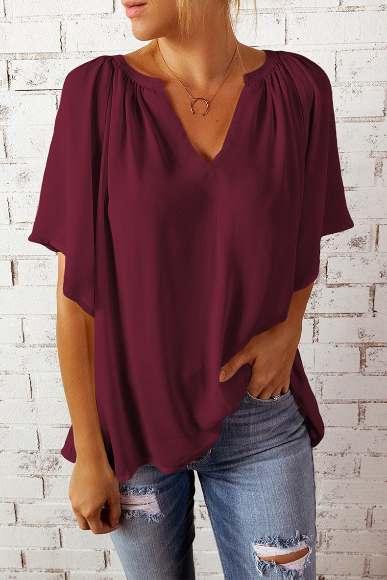 Blusa informal holgada de color liso con cuello en V y manga corta para mujer