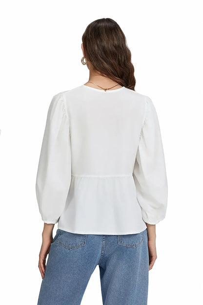 Blusa con mangas abullonadas, peplum y lazos