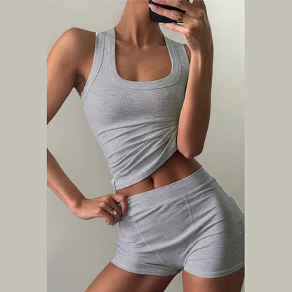 Conjunto de dos piezas formado por camiseta sin mangas y pantalones cortos de cintura alta, cuello redondo, color liso e informal, para mujer