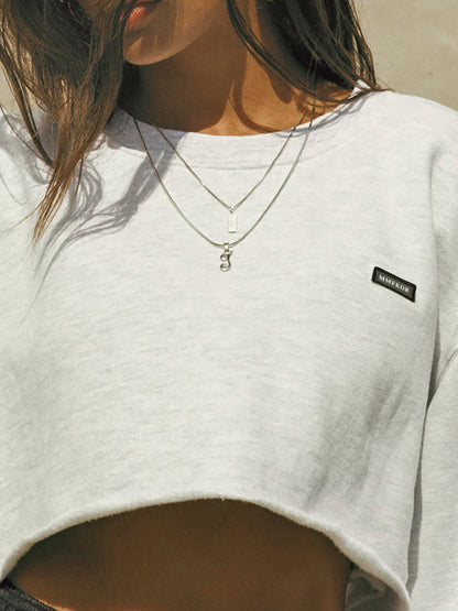 Sudadera corta informal de manga larga con cuello redondo y color liso para mujer